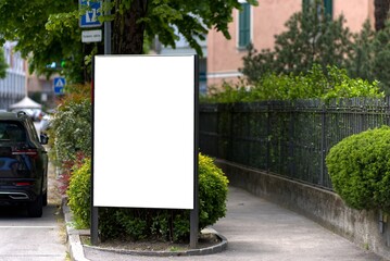 White billboard vertically on a street in Chiasso, Switzerland.