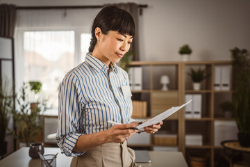 Portrait of japanese woman hold document at office
