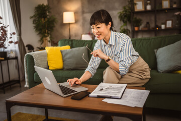Mature japanese woman work from home on laptop