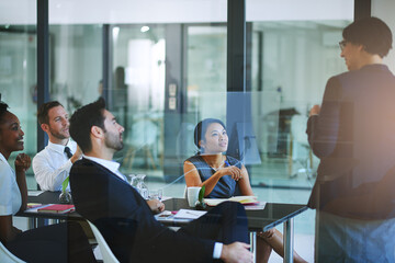 Business, presentation and woman in boardroom for meeting with team, coaching or corporate training. Group, learning and listening to speaker with ideas for leadership and project management