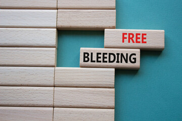 Free bleeding symbol. Concept words Free bleeding on wooden blocks. Beautiful grey green...