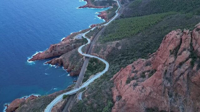 Aerial view of the Massif de L'Esterel and a beautiful winding road over the cliffs falling into the Mediterranean Sea. French Riviera. Cote d'Azur