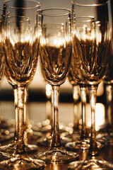 Champagne glasses on gold background. Party and holiday celebration concept