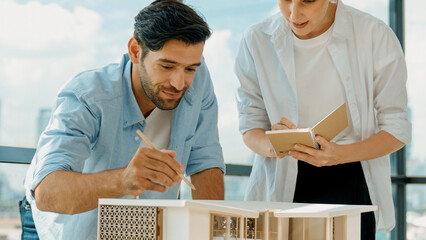 Skilled architect engineer team discussion about house model construction. Smart interior designer...