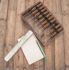 Old abacus, the paper with a pencile. Flat lay