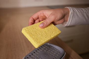 a sponge is sitting on top of a soap dispenser on a sink