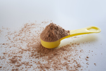 Close up of whey protein scoop on white background, copy space