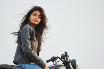 Fototapeta na wymiar Young indian female in black jacket rider with motorbike