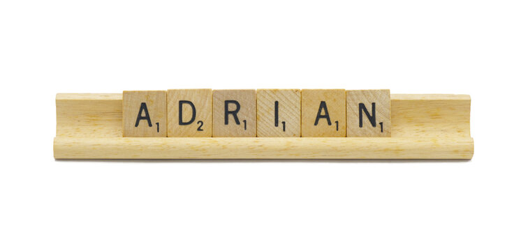 Miami, FL 4-18-24 popular baby boy first name of ADRIAN made with square wooden tile English alphabet letters with natural color and grain on a wood rack holder isolated on white background