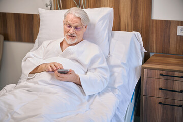 Senior male patient recovering from disease in hospital