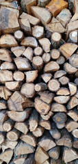 a lot of firewood stacked against the wall, wooden texture background