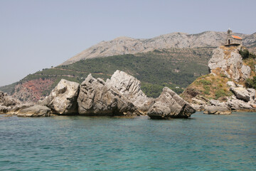 Fototapeta premium View of beautiful islets Katic Katich and Sveta Nedjelja with church on one of them in the sea near Petrovac, Montenegro.