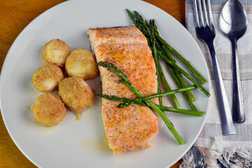 baked salmon served with scallops and asparagus