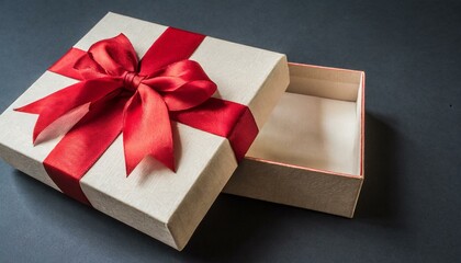 open gift box or present box with red ribbon and bow on black background with shadow