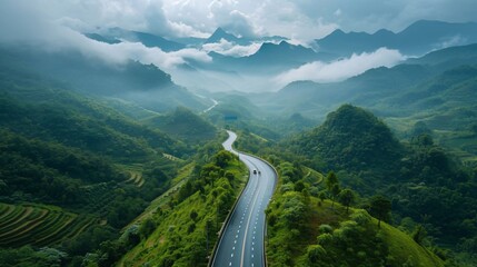 Serpentine mountain road, lush greenery and blue sky. Scenic route natural landscape, travel adventure concept.