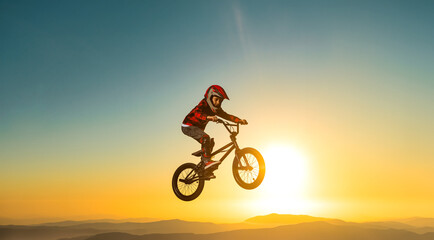 Obraz premium A teenager BMX Racing Rider performs tricks in a skate park on a pump track.