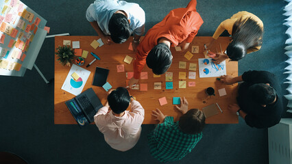 Top view of project manager working while marketing team support her performance. Caucasian...