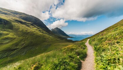 scotland mountain green ranges aerial view path between greenery grassy hills grey clouds wrapped top of mounts in summer day wild untouched nature scenery of island arran footage shot in 2k qhd