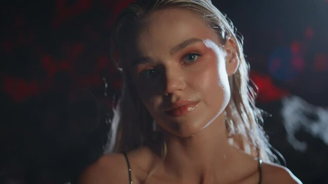 Seductive girl flirting camera at night closeup. Smiling blonde biting lips