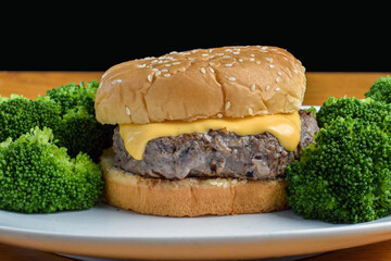 cheese burger on sesame  bun with broccoli