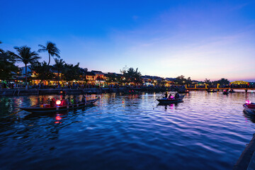 Hoi An ancient town and passenger boats on Thu Bon River at magic hour