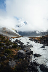 Alpine mountain landscape white peak with fog and river