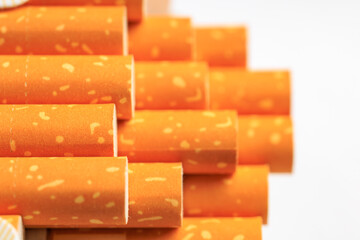 A stack of cigarettes with orange and yellow stripes