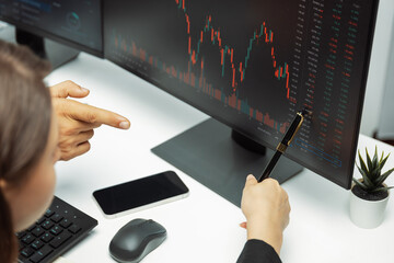 Focusing on hand pointing on pc screens with discussing dynamic stock market in two business...