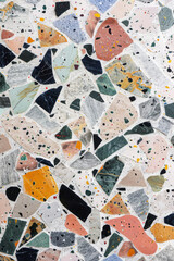 Textured surface of terrazzo flooring, featuring colorful aggregates embedded in a cement or resin base. Terrazzo textures offer a retro and eclectic backdrop, ideal for conveying a sense of nostalgia