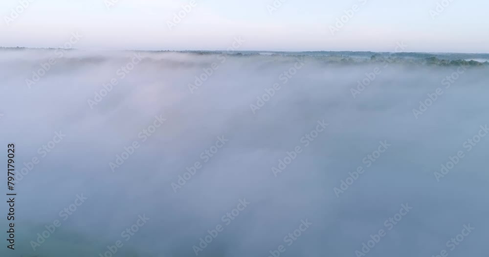 Poster the sky is covered in a thick layer of fog, creating a sense of mystery and calmness, areal video