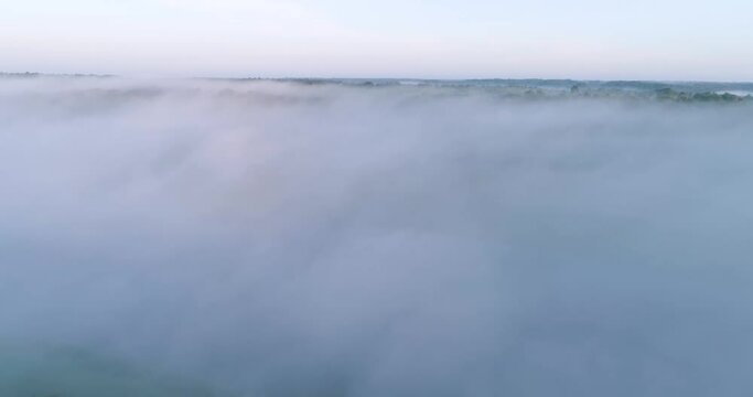 The sky is covered in a thick layer of fog, creating a sense of mystery and calmness, areal video