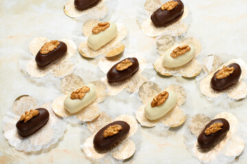 walnut cameo covered in white chocolate and dark chocolate decorated with golden walnuts