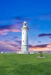 Beautiful lighthouse at Sunset over the Pacific Ocean on cliffs of Kiama Sydney NSW Australia...