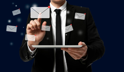 Incoming email. Man touching virtual envelope over tablet against dark blue background, closeup