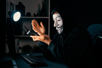 White smiling criminal anonymous mask calling to victim, convince to hack personal information,...