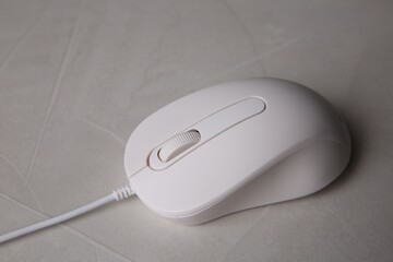 One wired mouse on grey textured table, closeup