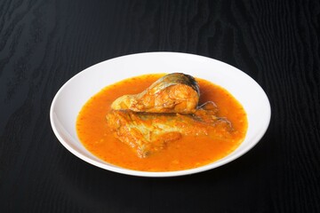 Ikan Patin Masak Tempoyak in a white plate, Ikan Patin Tempoyak is a famous Sumatera heritage dish and it taste spicy.