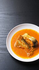Ikan Patin Masak Tempoyak in a white plate, Ikan Patin Tempoyak is a famous Sumatera heritage dish and it taste spicy.