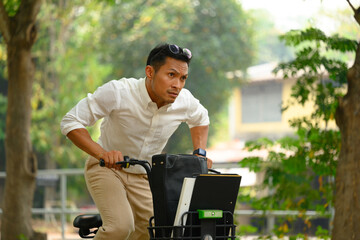Businessman commuting riding bicycle go to work during the morning rush