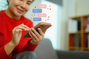 Smiling young woman using mobile smartphone with comment and social media icons - 797238819