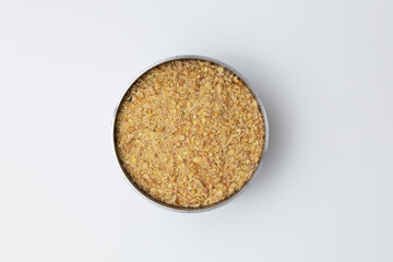 Ground flax seeds in a bowl isolated against a white background.