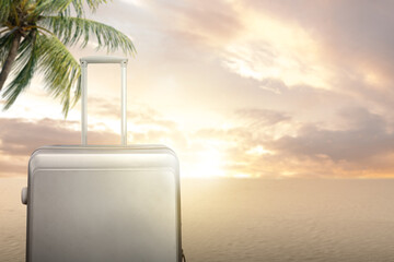 Image of soft grey suitcase with beautiful sunset view on background.