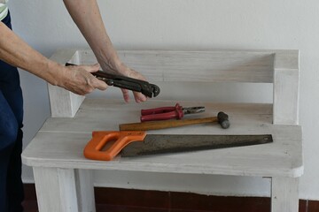 Preparing tools to do carpentry work at home .-