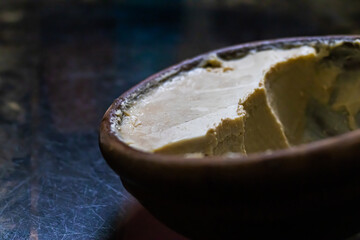 mishti doi or dahi or sweet yogurt being served earthen bowl. This fermented curd is very popular dessert in west bengal, bangladesh & tripura. It is made of milk and jaggery.