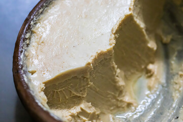mishti doi or dahi or sweet yogurt being served earthen bowl. This fermented curd is very popular...
