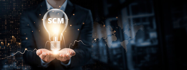 SCM: Supply Chain Management, Sustainability concept. Hands of businessman holding light bulb and...