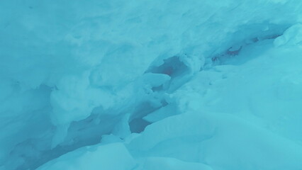 Blue Ice Cave Crack in Antarctic Turquoise Iceberg. Polar Winter Deep Hole in Crystal Mountain....