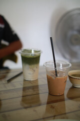 Closeup of Iced Caramel Macchiato at the coffee shop, Caramel Macchiato is a classic macchiato beverage. It consists of vanilla syrup, espresso, steamed milk, foam, and caramel drizzle