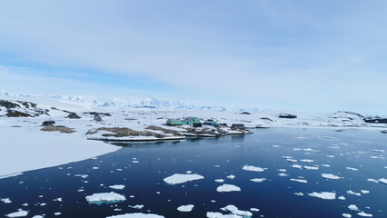 Aerial view of Vernadsky Base station at Antarctica Peninsula's. Antarctic ocean coast with melting...