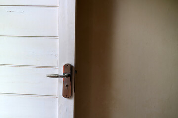a white wooden door with white walls. with door handles made of aluminum